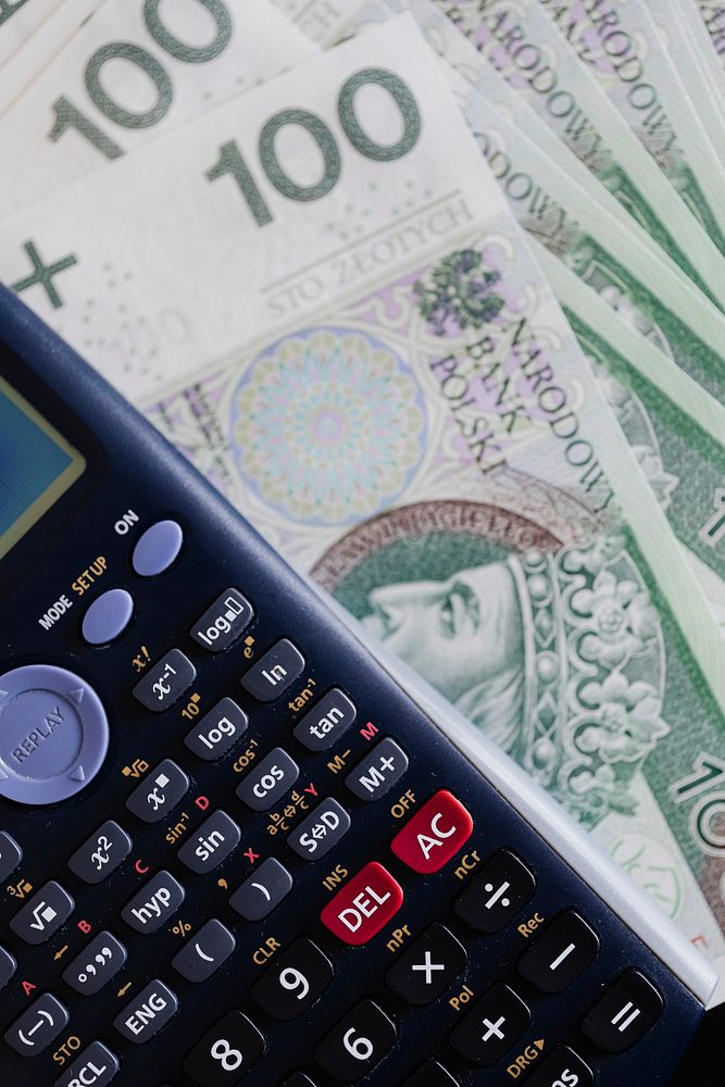 Calculator and Polish Zloty currency banknotes on a table