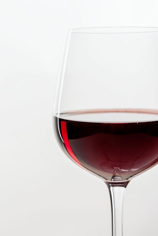 Red wine in a glass on white background