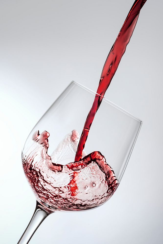 Red wine pouring into a wine glass