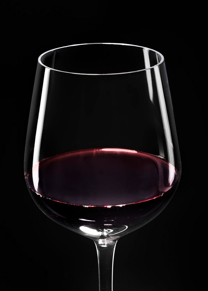 Wine glass with red wine on black background