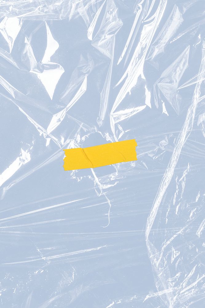 Yellow tape on a wrinkled plastic wrap textured background