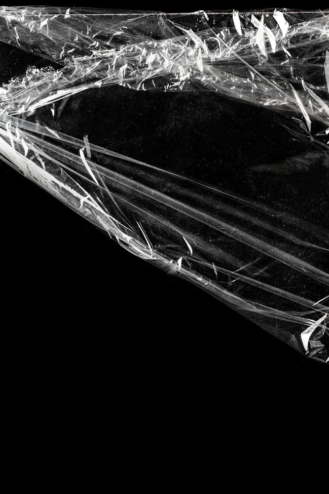 Wrinkled plastic wrap texture on a black background