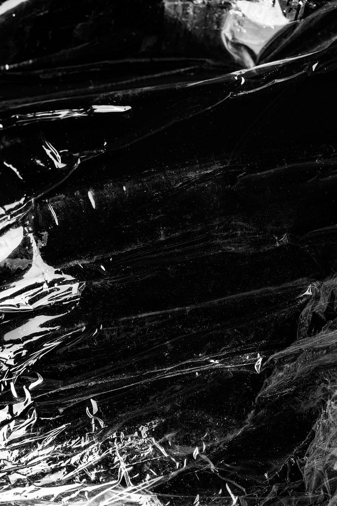 Wrinkled plastic wrap texture on a black background