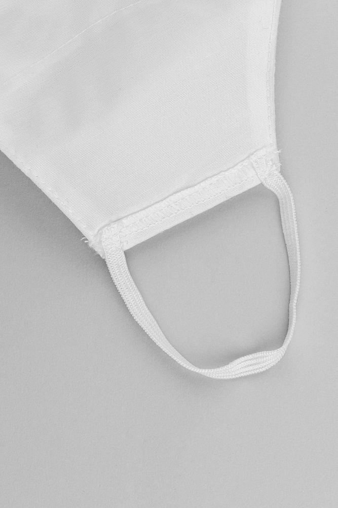 White fabric face mask on off white background