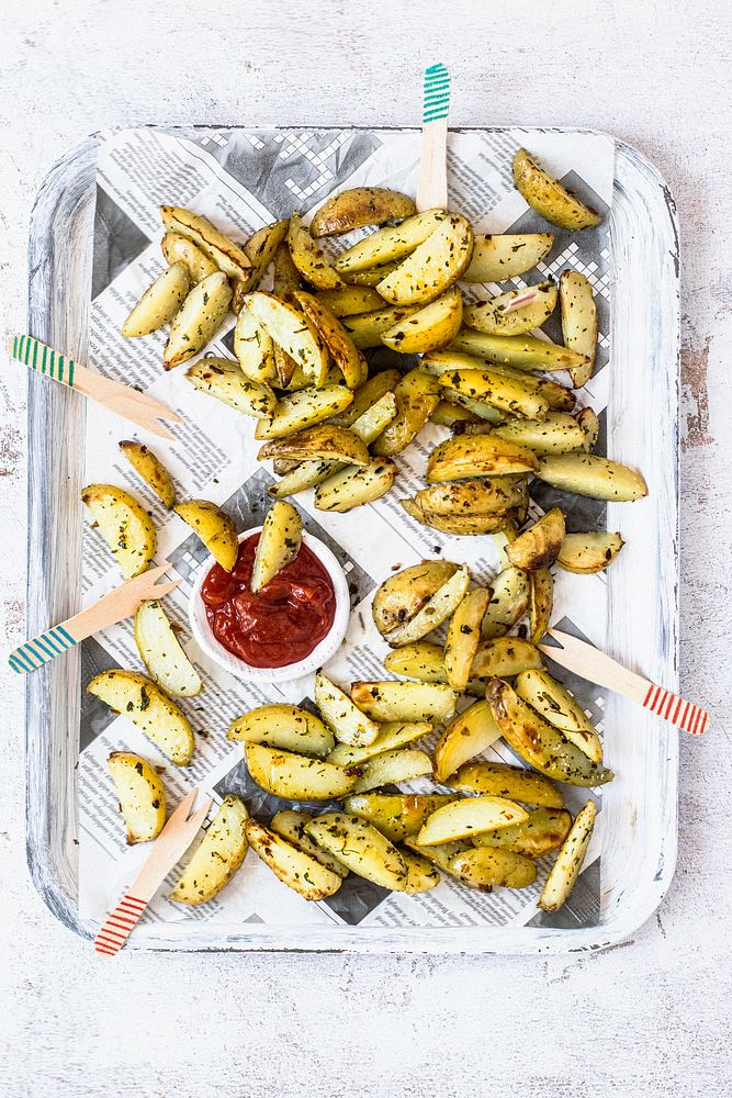 Potato wedges with ketchup on a tray