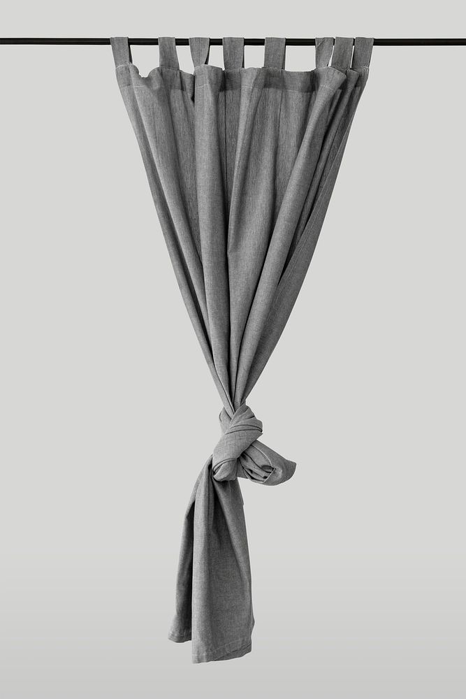 Gray drapery hanging from a curtain rod