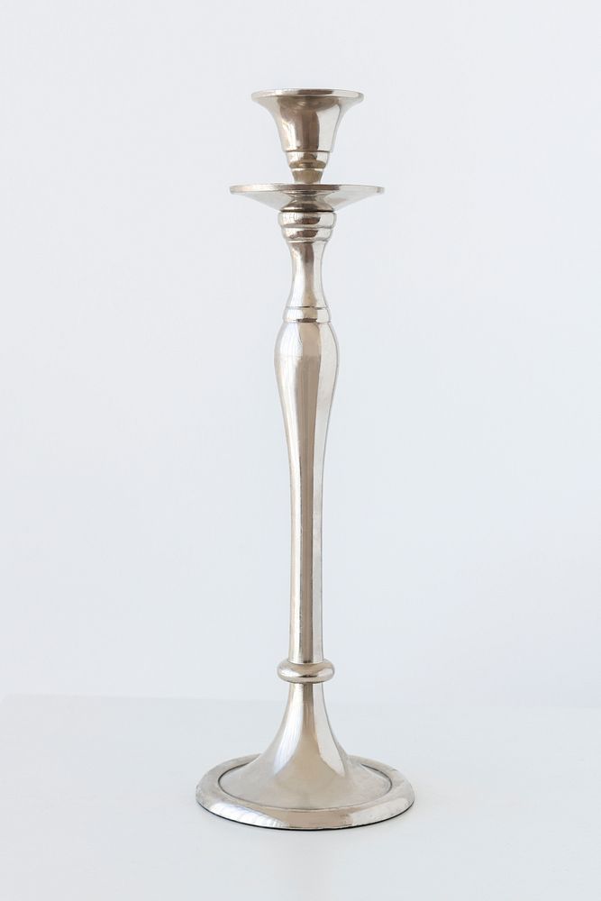Traditional silver candle holder on off white background