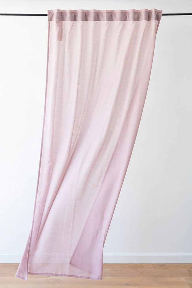 Pink drapery curtain hanging from a curtain rod