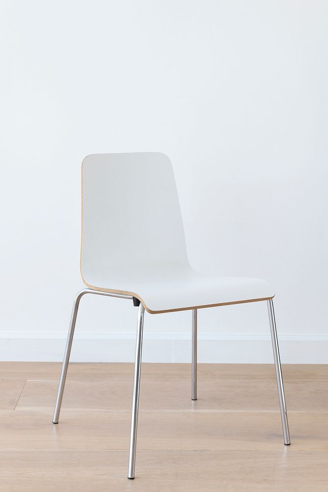 Modern white chair on wooden floor