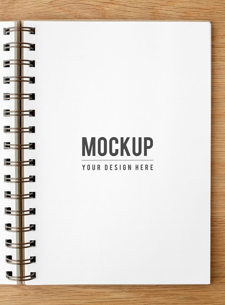 White ruled notebook mockup on a wooden table