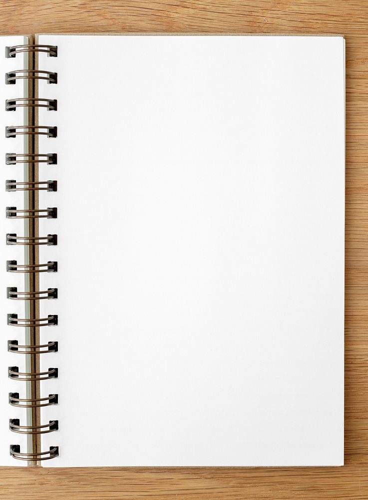 Blank white ruled notebook on a wooden table