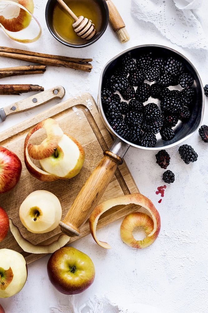 Organic blackberry in a pot and carved fresh apples
