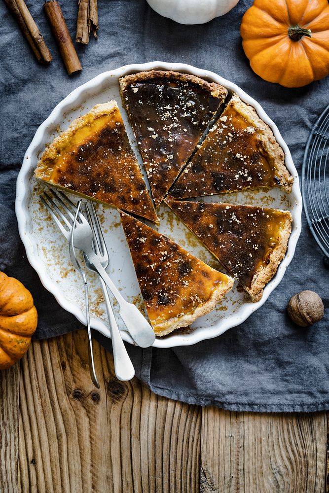 Pumpkin pie slices in a plate halloween dessert flat lay