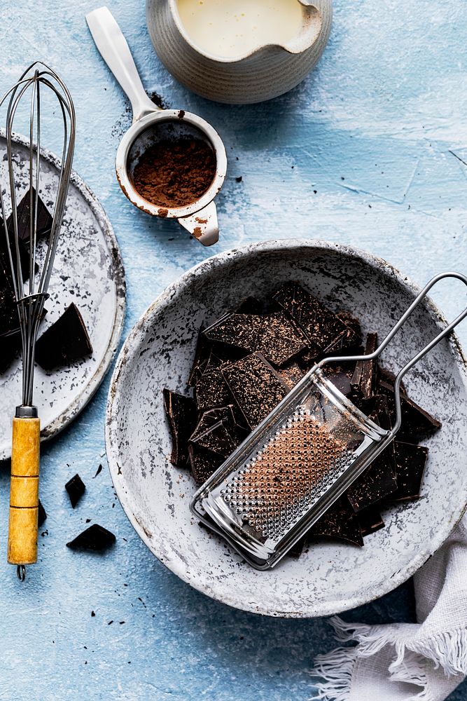 Dark chocolate and grater on a kitchen table