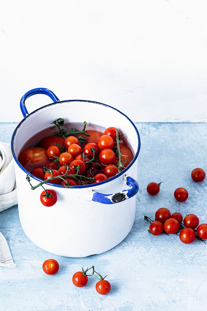 Freshly washed tomatoes in a pot