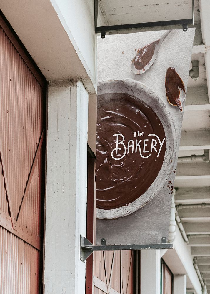 Signage mockup psd in front of a bakery shop