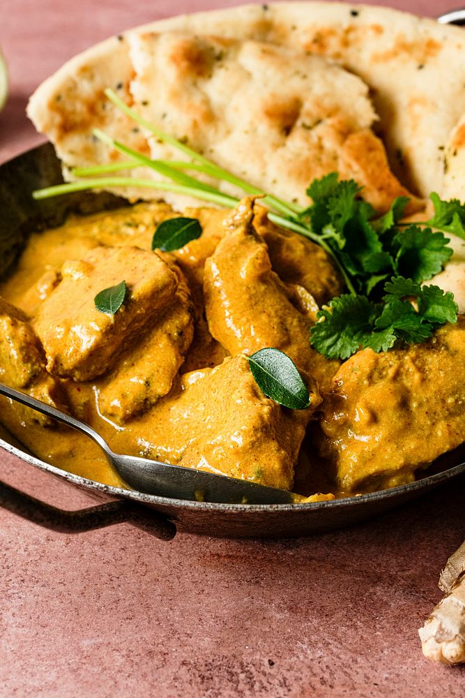 Butter chicken Indian curry in a pan food photography