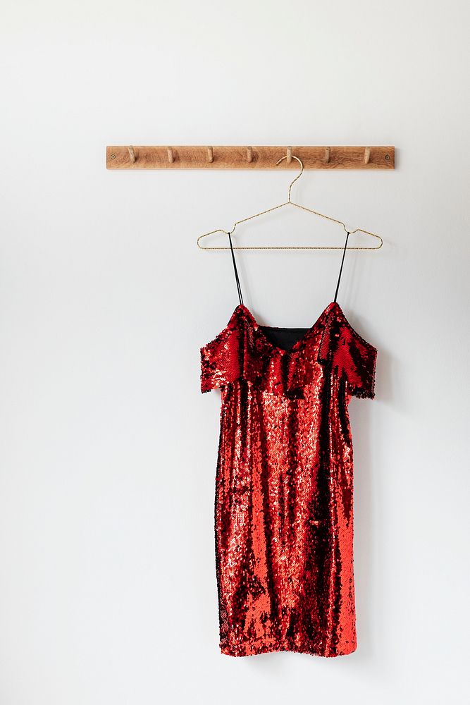 Red off shoulder sequin dress on a wall hanger