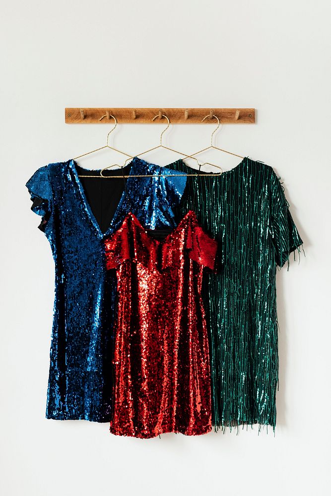 Shiny party dresses on a wall hanger