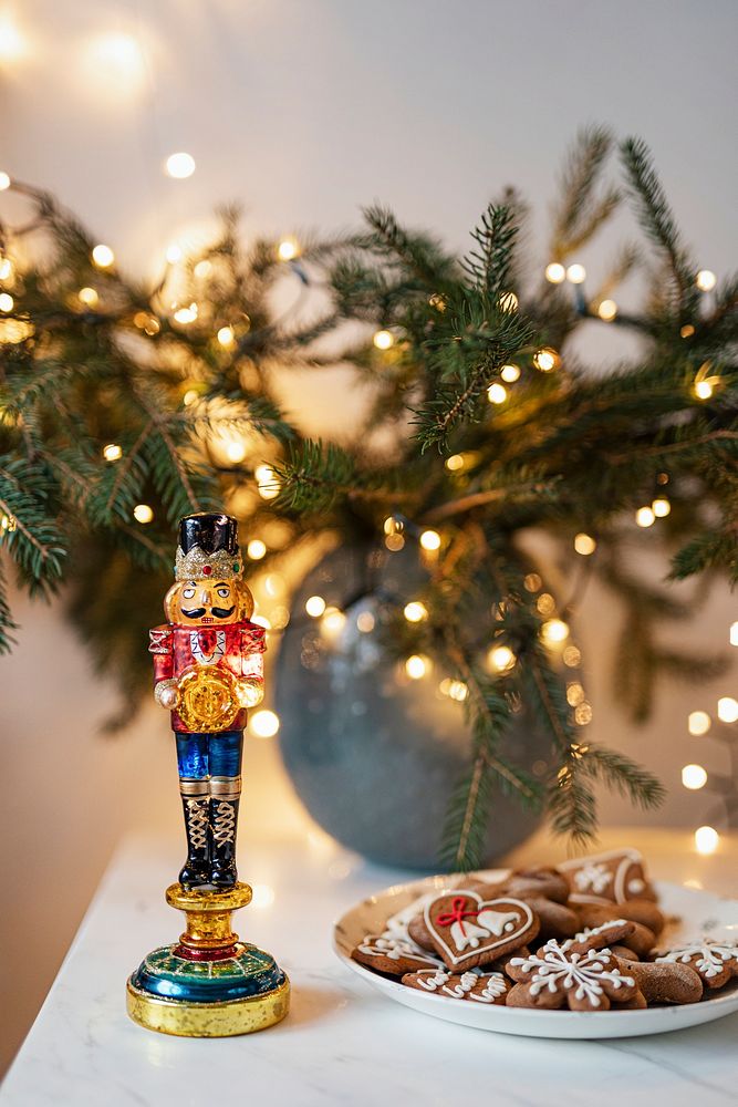 Decorative nutcracker on a countertop by the gingerbread cookies 