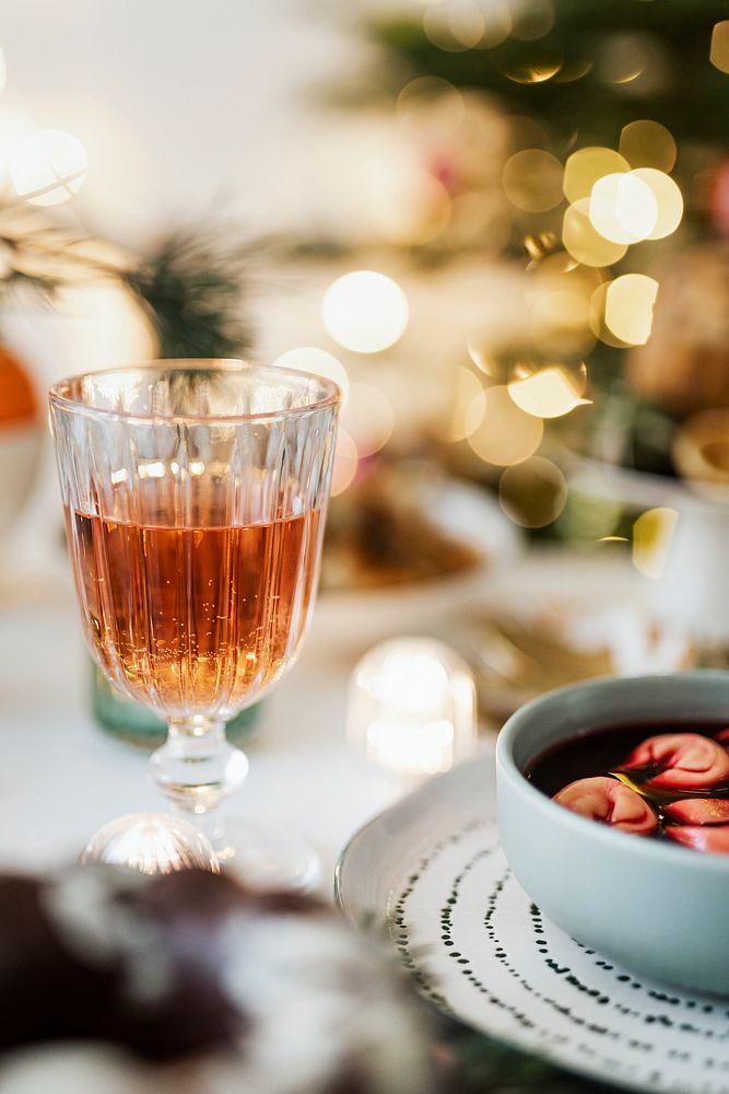 Christmas table setting with a glass of alcohol 