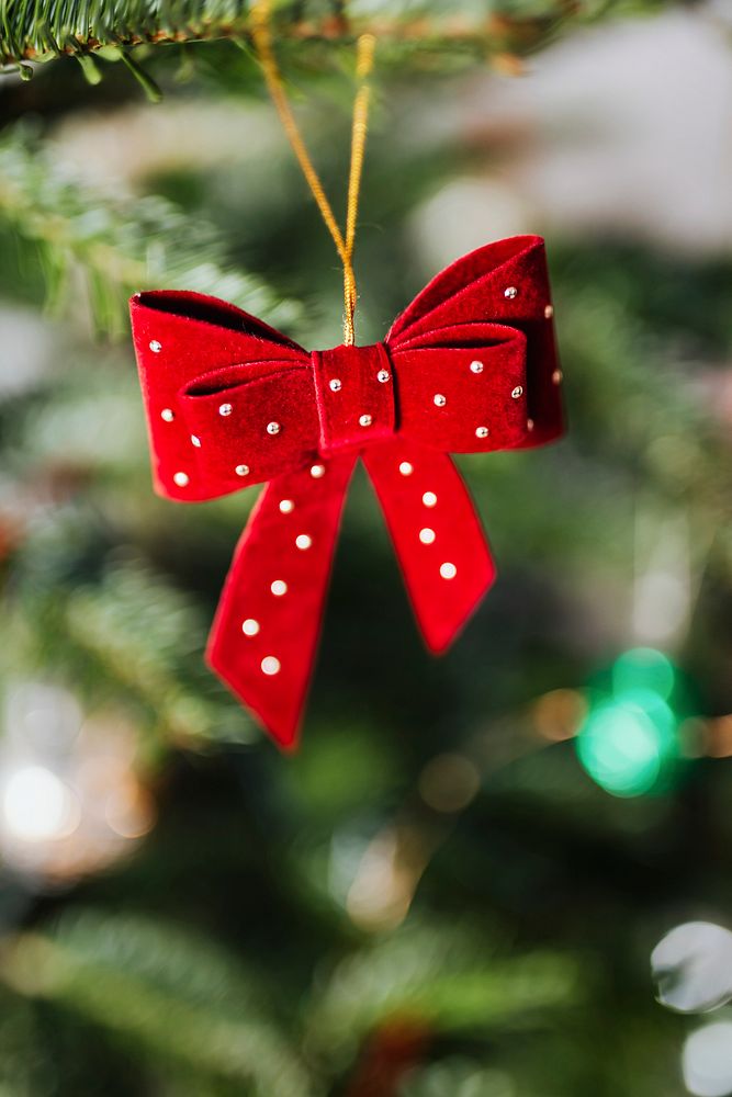 Red ribbon hanging on a Christmas tree