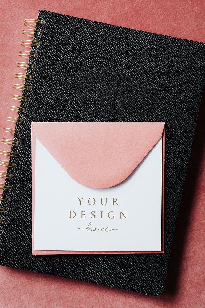 Pink envelope mockup on a black notebook