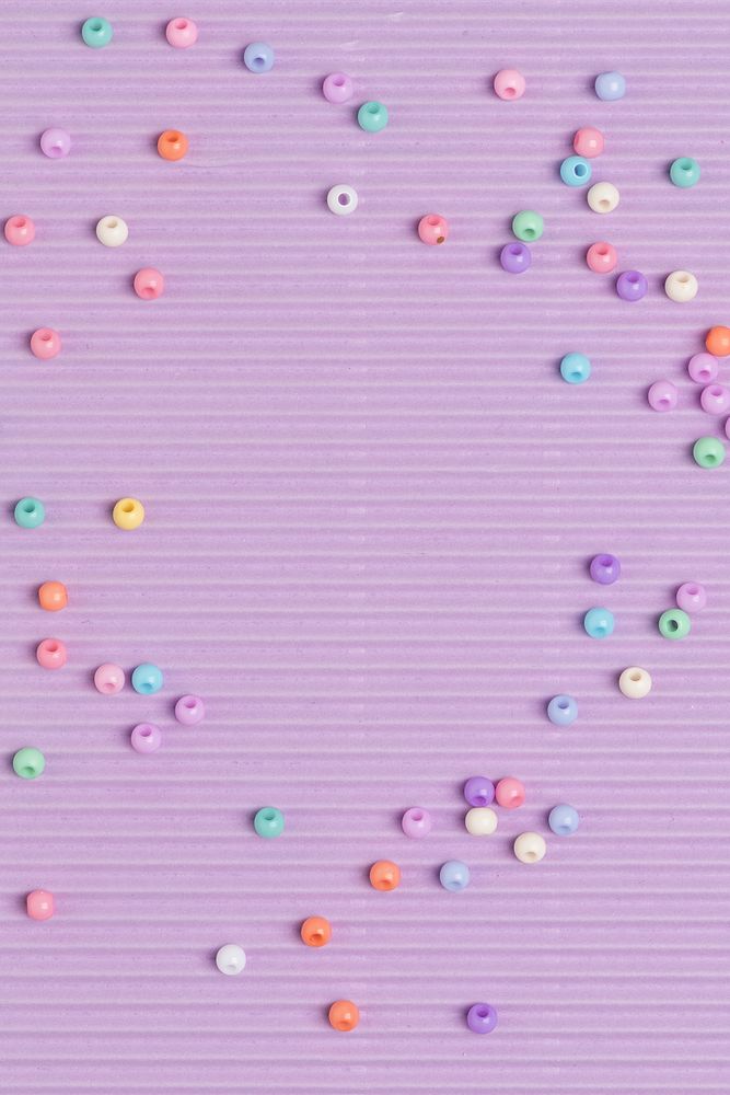 Pastel beads border purple background