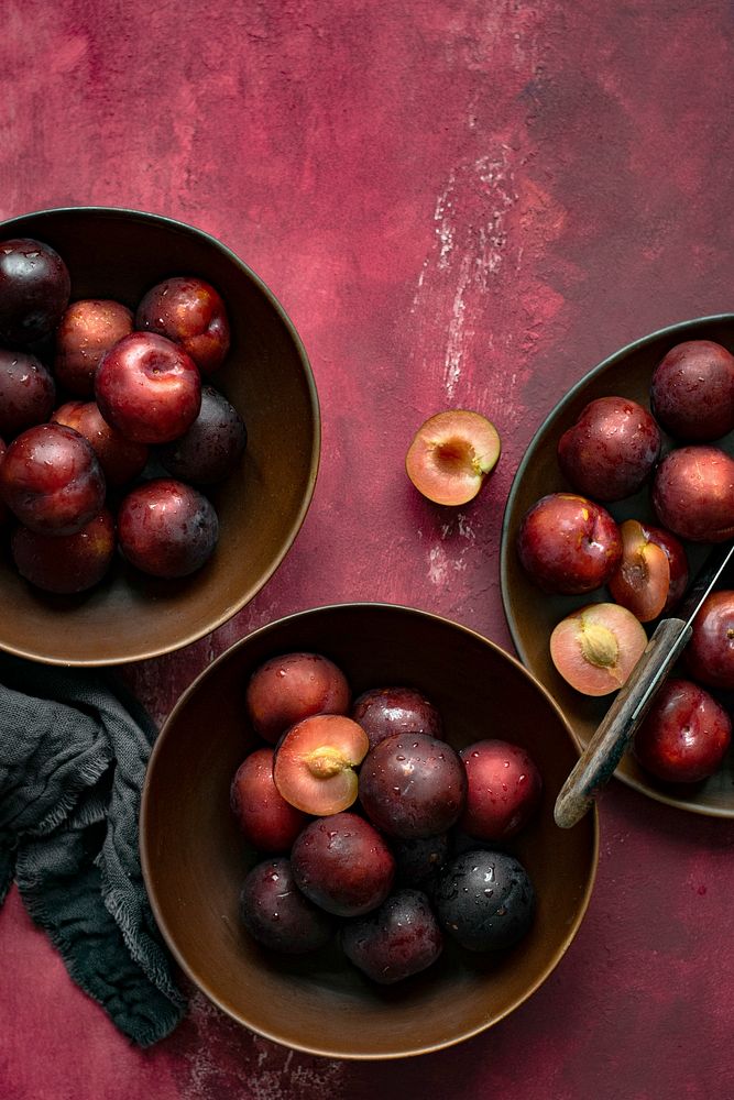 Red plums in a bowl summer food flatlay