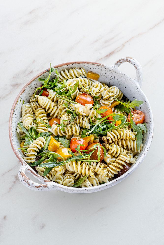 Rotini pasta salad with arugula and cherry tomatoes, healthy summer dish