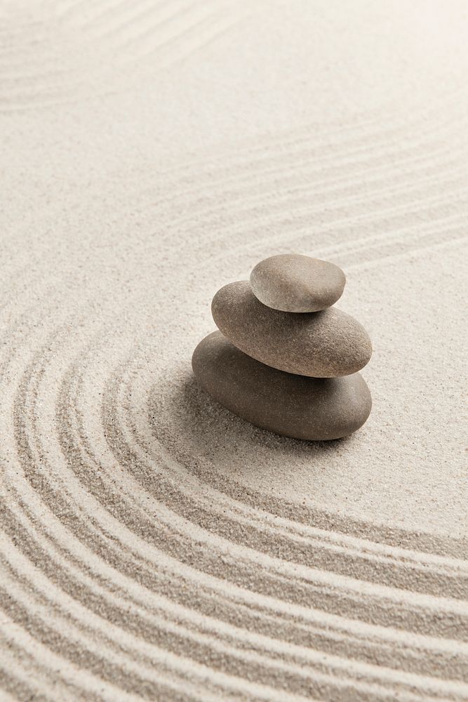 Stacked zen stones sand background art of balance concept