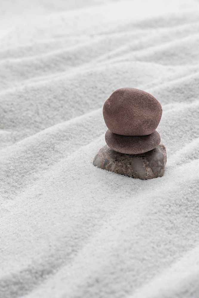 Stacked zen stones sand background in art of balance concept