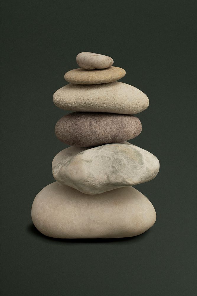 Marble zen psd stones stacked on green background in stability concept