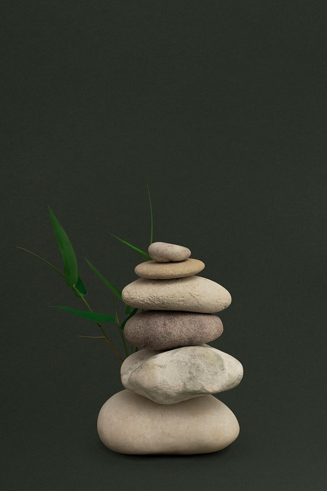 Marble zen stones stacked on green background in art of balance concept