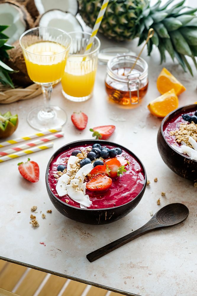 Acai smoothie in coconut shell with orange juice