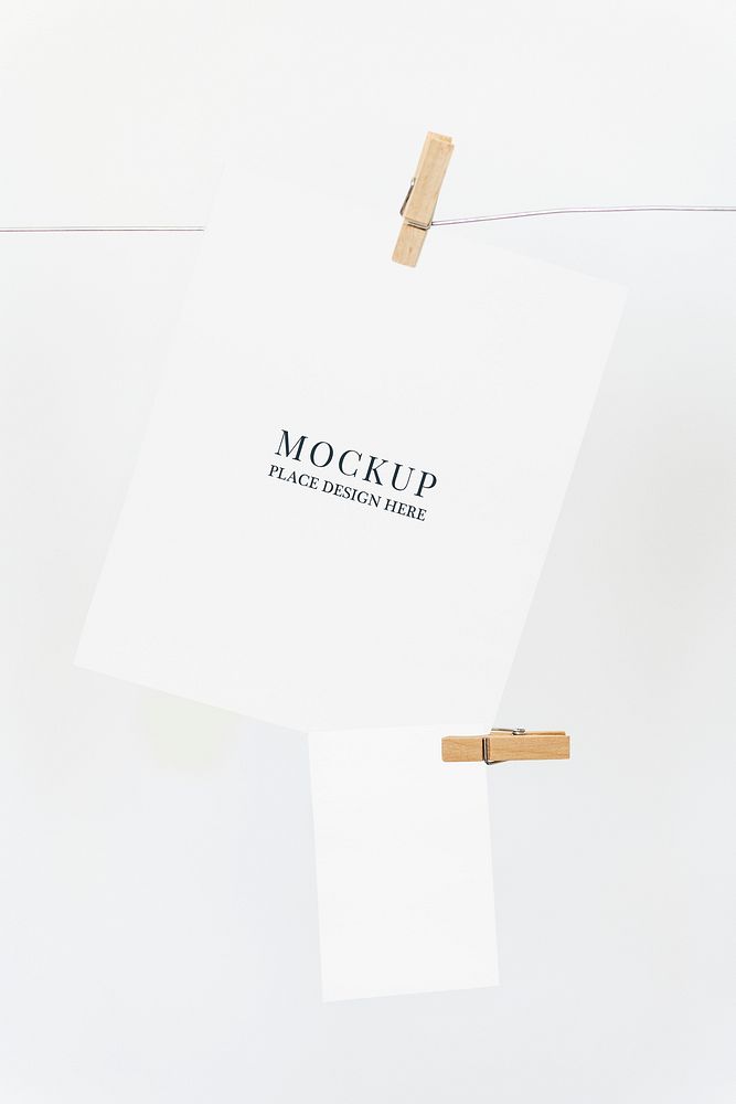 Papers mockup psd hanging from a rope with paper clips