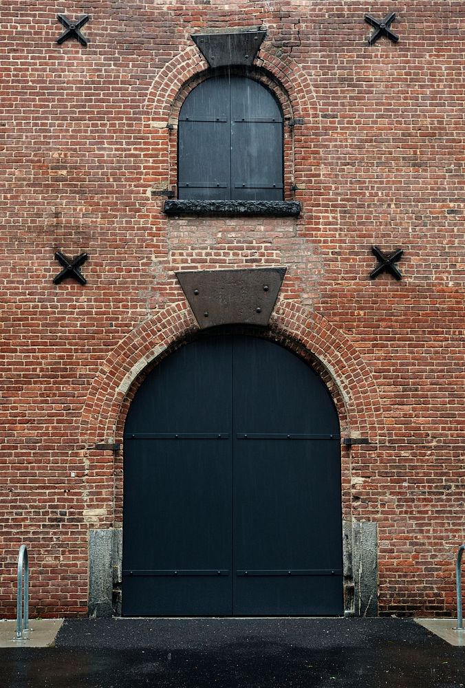 Black retro door with a brick building