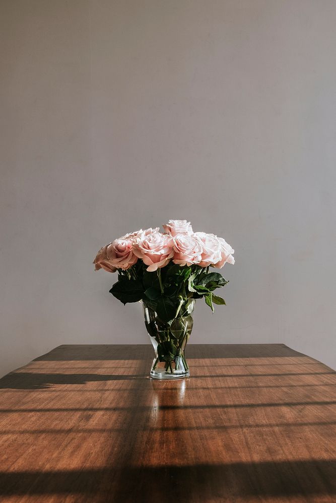 Beautiful pink roses in a vase on a table