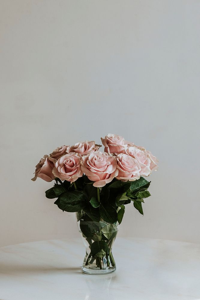 Beautiful pink roses in a vase on a table