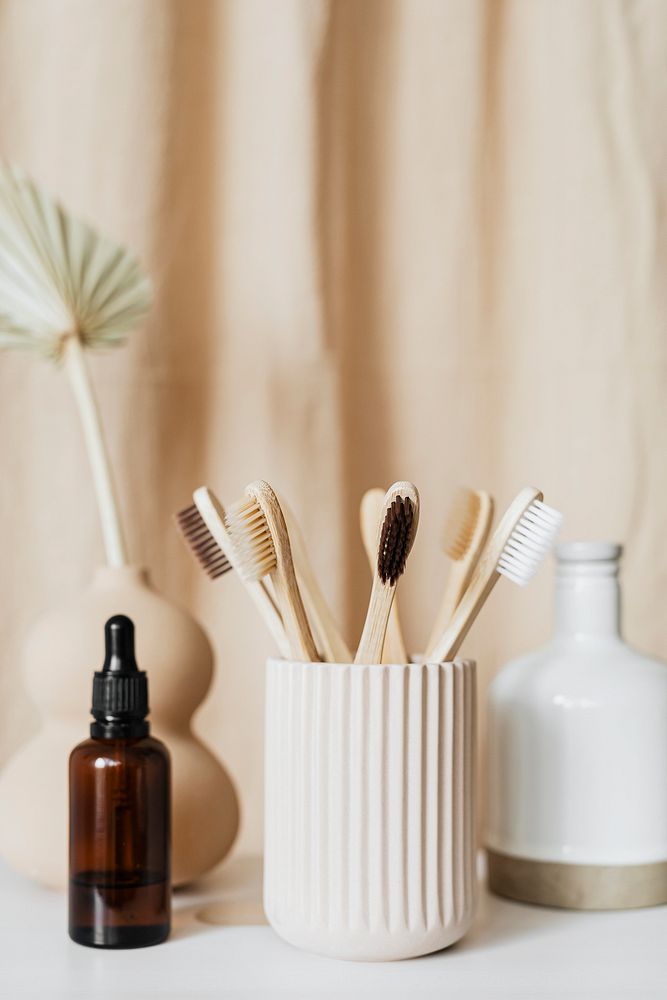 Brown dropper bottle and bamboo toothbrushes still life