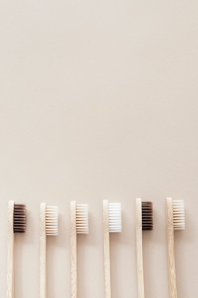 Bamboo toothbrushes on a beige background