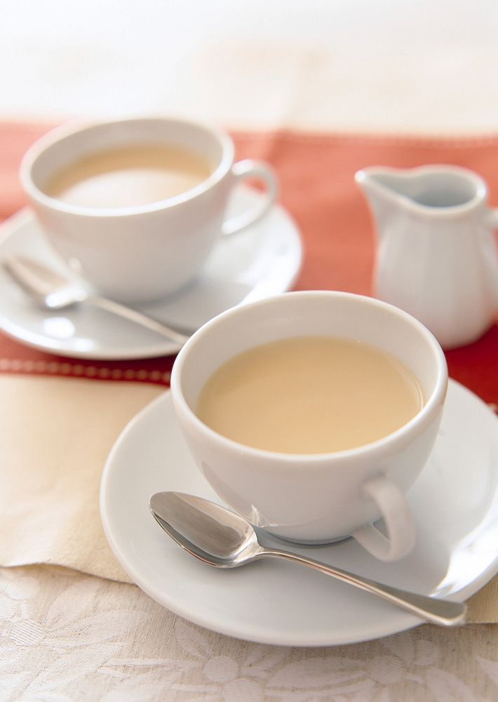 Free tea with milk, white saucer photo, public domain beverage CC0 image.