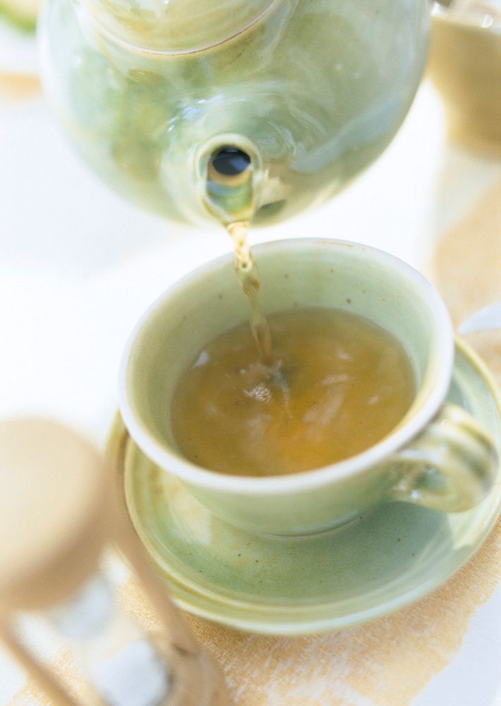 Free pouring green tea from ceramic teapot photo, public domain beverage CC0 image.