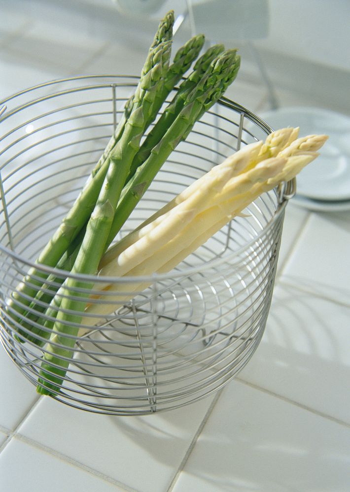 Free image of a bunch of green and white asparagus in steel basket, public domain CC0 photo.