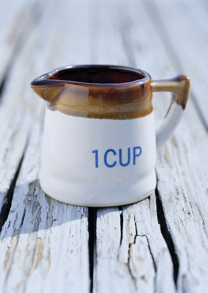 Free porcelain milk jug on wooden background photo, public domain beverage CC0 image.