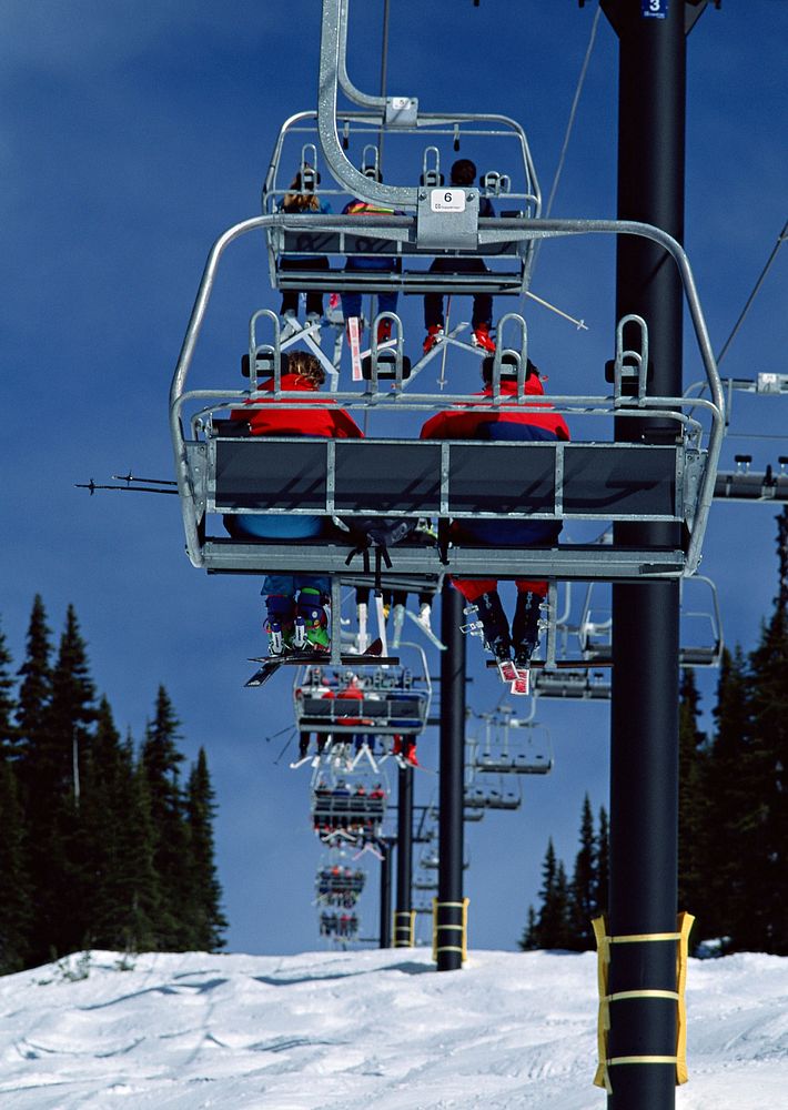 Skiers and snow boarders on cable car image, public domain CC0 photo.