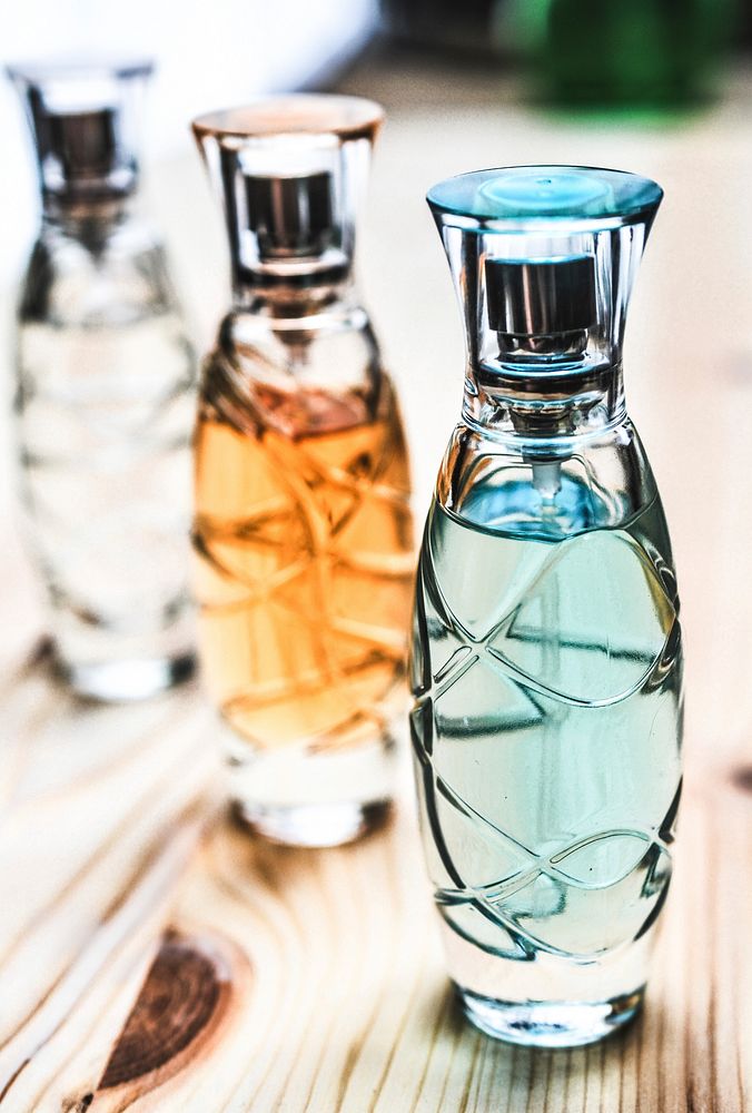 Free colorful perfume on wooden table image, public domain CC0 photo.