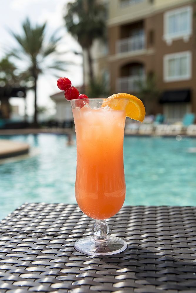Free tropical cocktail with pool background photo, public domain beverage CC0 image.