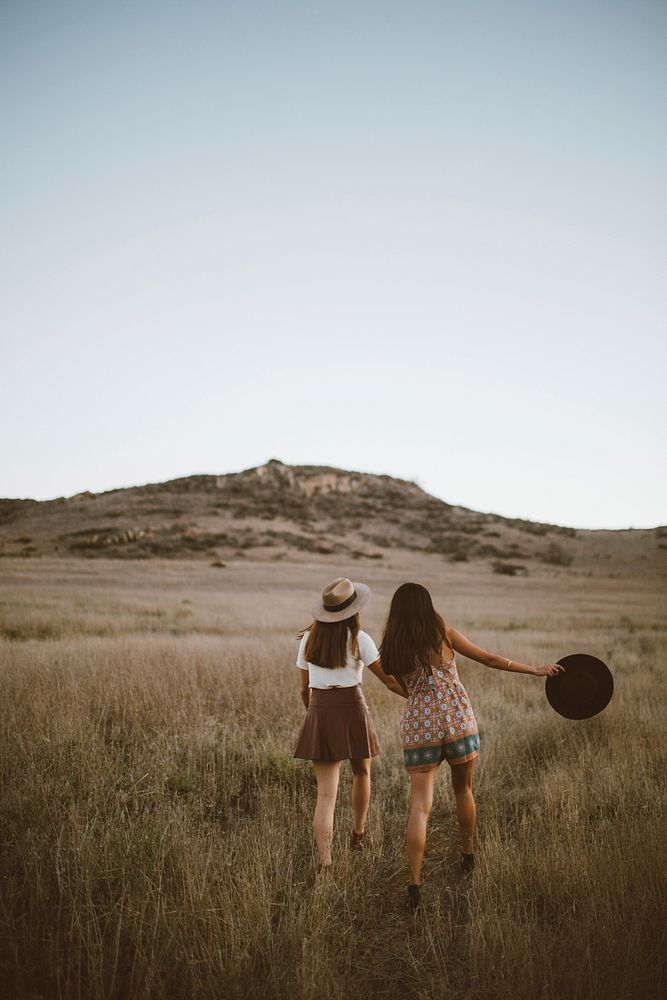 ladies walking through grass field, free public domain CC0 photo