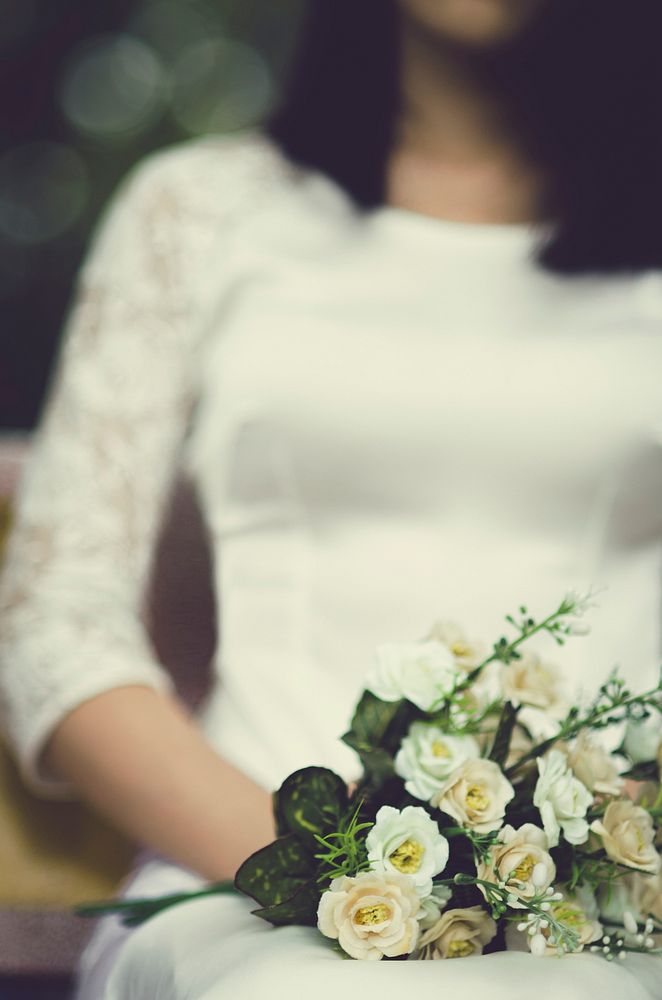 Free bride holding flower bouquet image, public domain CC0 photo.